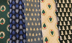 Five pieces of Christmas tree-themed fabric